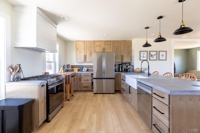 355 Camellia, Hurt, VA 24563 - kitchen with a sink, light brown cabinetry, a peninsula, premium range hood, and appliances with stainless steel finishes