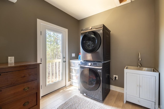 355 Camellia, Hurt, VA 24563 - washroom featuring stacked washer / drying machine, laundry area, light wood finished floors, and a sink