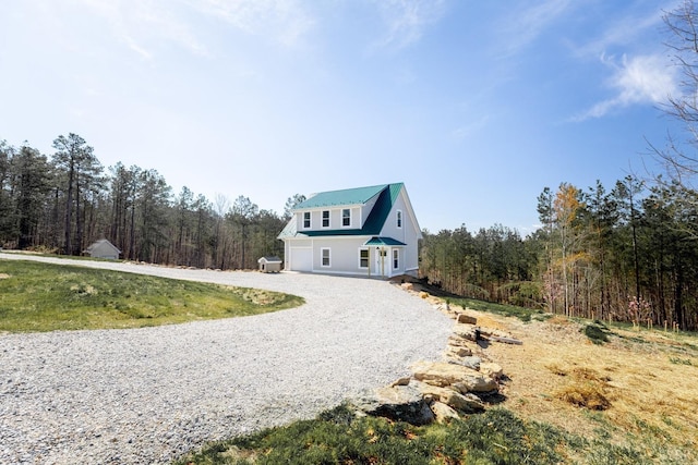 355 Camellia, Hurt, VA 24563 - view of home's exterior with gravel driveway, metal roof, and a forest view