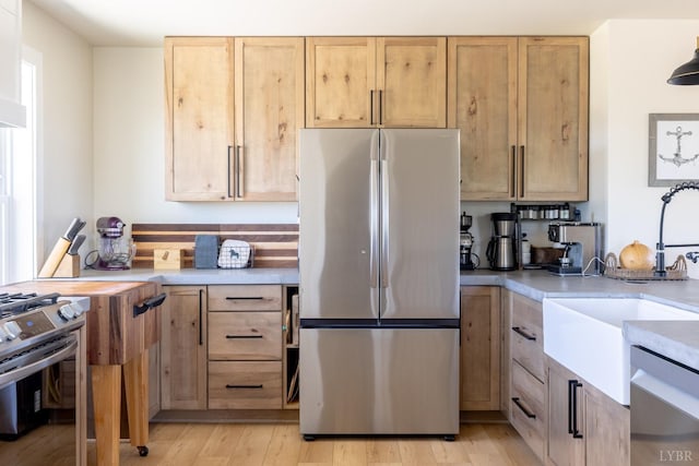 355 Camellia, Hurt, VA 24563 - kitchen featuring light brown cabinets, stainless steel appliances, light countertops, and a sink