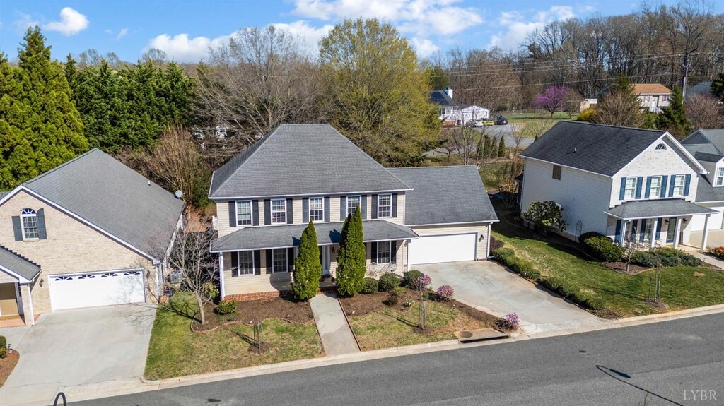 213 Duncraig Dr, Lynchburg, VA 24502 - view of front facade featuring driveway, roof with shingles, a front lawn, a residential view, and a garage