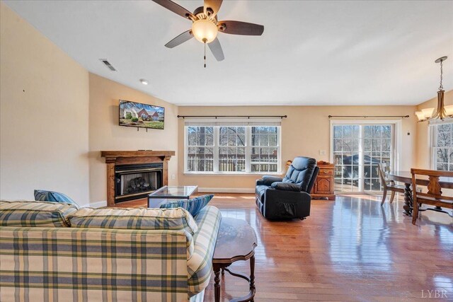 200 Inlet Dr, Wirtz, VA 24184 - living area with a chandelier, a fireplace, wood finished floors, ceiling fan, and lofted ceiling