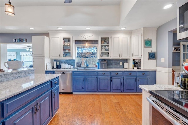 1014 Tall Tree Rd, Wirtz, VA 24184 - kitchen featuring stainless steel appliances, blue cabinets, a sink, white cabinets, and decorative backsplash