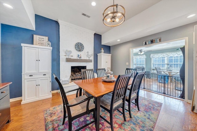 1014 Tall Tree Rd, Wirtz, VA 24184 - dining area with light wood-style flooring, a chandelier, a brick fireplace, recessed lighting, and baseboards