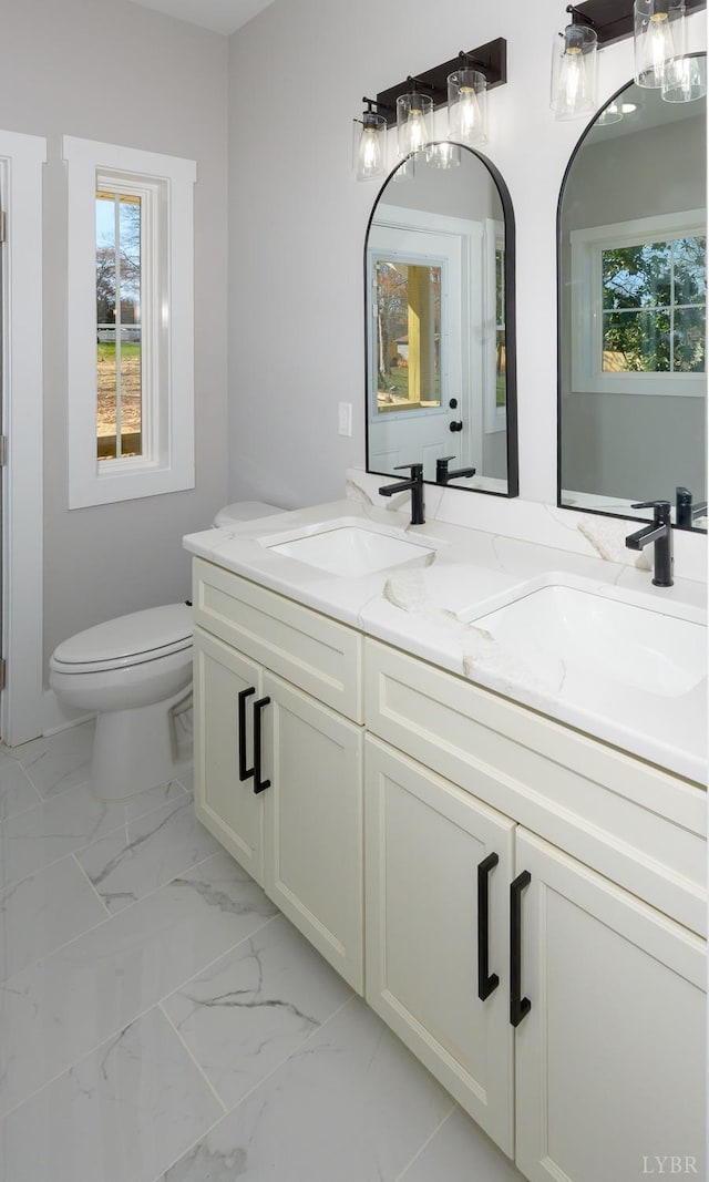 3936 Moorman Dr, Lynchburg, VA 24501 - bathroom with healthy amount of natural light, double vanity, toilet, and marble look tiles
