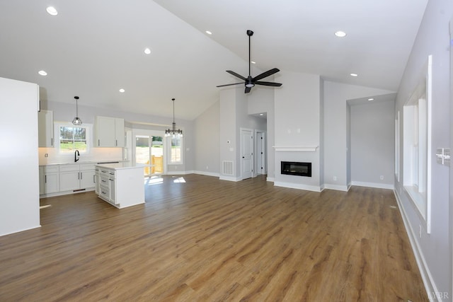 3936 Moorman Dr, Lynchburg, VA 24501 - unfurnished living room with a sink, high vaulted ceiling, ceiling fan, wood finished floors, and baseboards