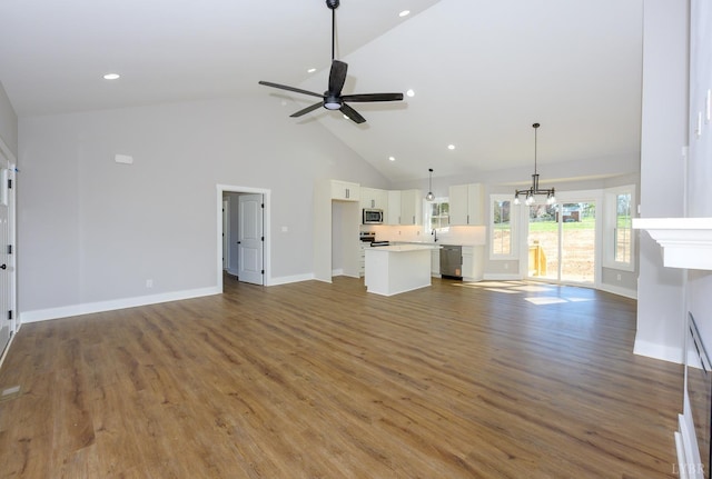 3936 Moorman Dr, Lynchburg, VA 24501 - unfurnished living room featuring high vaulted ceiling, a ceiling fan, wood finished floors, baseboards, and recessed lighting