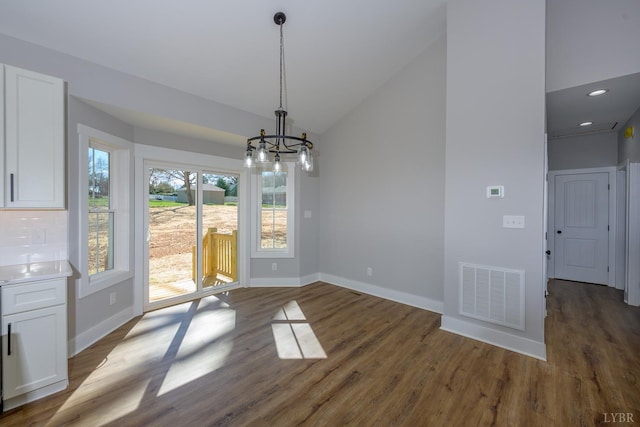 3936 Moorman Dr, Lynchburg, VA 24501 - unfurnished dining area featuring a chandelier, baseboards, dark wood-style flooring, and high vaulted ceiling