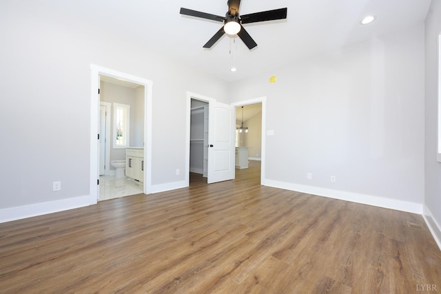 3936 Moorman Dr, Lynchburg, VA 24501 - unfurnished bedroom featuring a spacious closet, wood finished floors, baseboards, connected bathroom, and recessed lighting