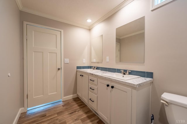 1381 Moccasin Path Trl, Huddleston, VA 24104 - bathroom featuring a sink, toilet, baseboards, wood finished floors, and ornamental molding