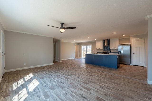 1381 Moccasin Path Trl, Huddleston, VA 24104 - kitchen with appliances with stainless steel finishes, white cabinetry, open floor plan, baseboards, and ornamental molding