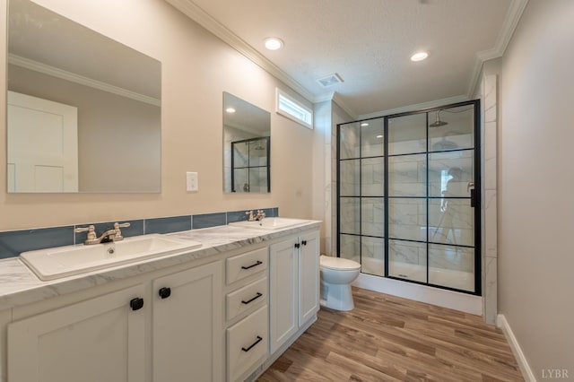 1381 Moccasin Path Trl, Huddleston, VA 24104 - full bathroom featuring crown molding, a sink, double vanity, a shower stall, and wood finished floors