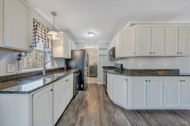 1309 Gate Ln, Moneta, VA 24121 - kitchen with dark stone countertops, a textured ceiling, a sink, dark wood-style floors, and appliances with stainless steel finishes