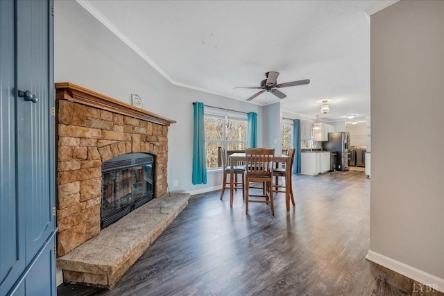 1309 Gate Ln, Moneta, VA 24121 - dining area with dark wood-style floors, a fireplace, ornamental molding, and a ceiling fan
