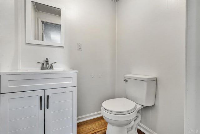 1330 Springfield Dr, Vinton, VA 24179 - half bathroom featuring baseboards, vanity, toilet, and wood finished floors