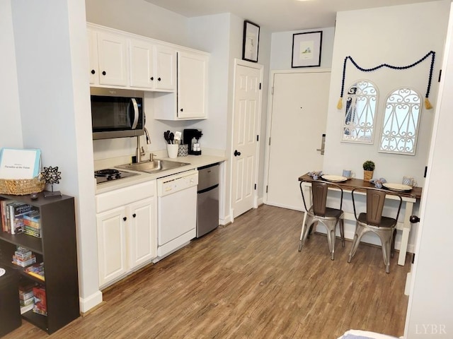 1245 Graves Harbor Dr Unit 2103, Huddleston, VA 24104 - kitchen with white cabinetry, light countertops, stainless steel appliances, a sink, and wood finished floors