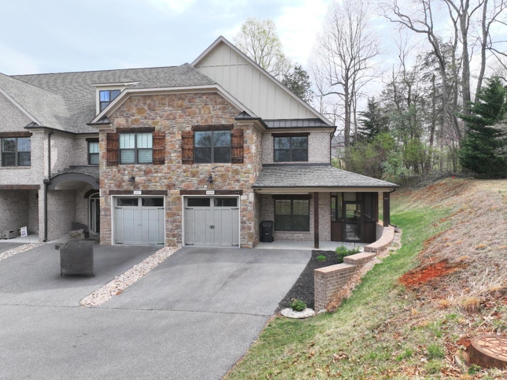1039 Tori Ct, Forest, VA 24551 - view of front of home with board and batten siding, driveway, a garage, and stone siding