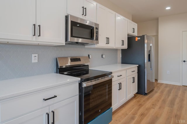 128 Brenleigh Ct Unit 102, Lynchburg, VA 24501 - kitchen with stainless steel appliances, light countertops, light wood-type flooring, backsplash, and white cabinets