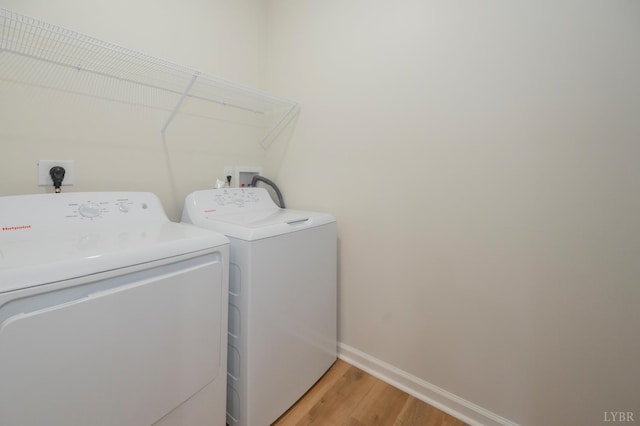 128 Brenleigh Ct Unit 102, Lynchburg, VA 24501 - laundry room featuring washing machine and dryer, baseboards, and light wood finished floors