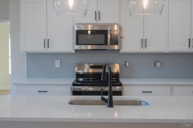 128 Brenleigh Ct Unit 102, Lynchburg, VA 24501 - kitchen featuring stainless steel appliances, white cabinetry, tasteful backsplash, and decorative light fixtures