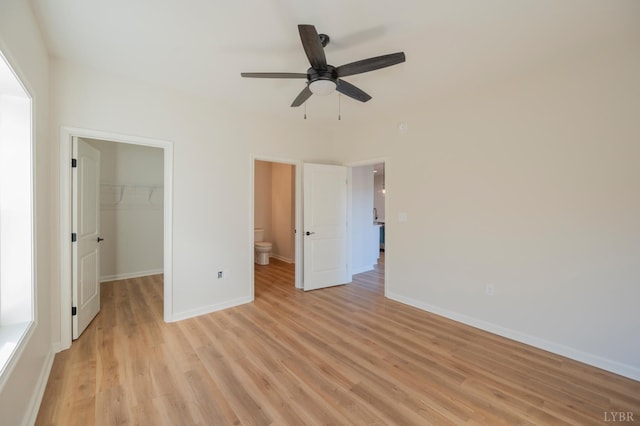 128 Brenleigh Ct Unit 102, Lynchburg, VA 24501 - unfurnished bedroom with a walk in closet, light wood-type flooring, baseboards, a closet, and ceiling fan