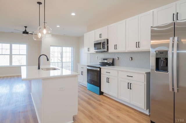 128 Brenleigh Ct Unit 102, Lynchburg, VA 24501 - kitchen with appliances with stainless steel finishes, a sink, backsplash, light countertops, and light wood-type flooring