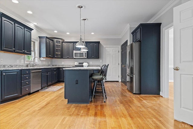 352 Wild Turkey Rd, Lynchburg, VA 24502 - kitchen with appliances with stainless steel finishes, crown molding, a kitchen island, light wood-type flooring, and a breakfast bar area