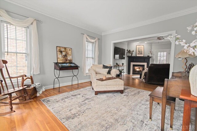 352 Wild Turkey Rd, Lynchburg, VA 24502 - living area featuring a glass covered fireplace, crown molding, wood finished floors, and a ceiling fan