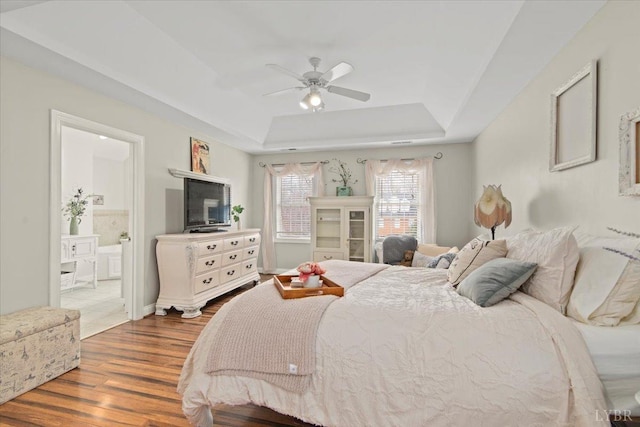 352 Wild Turkey Rd, Lynchburg, VA 24502 - bedroom featuring a tray ceiling, wood finished floors, connected bathroom, and ceiling fan