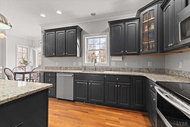 352 Wild Turkey Rd, Lynchburg, VA 24502 - kitchen featuring stainless steel appliances, crown molding, light wood-style floors, glass insert cabinets, and light stone counters