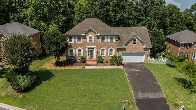 352 Wild Turkey Rd, Lynchburg, VA 24502 - colonial house featuring driveway, a front yard, a garage, and brick siding