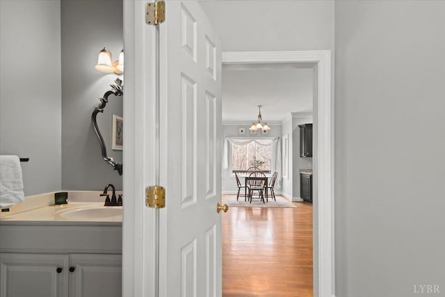352 Wild Turkey Rd, Lynchburg, VA 24502 - bathroom with ornamental molding, wood finished floors, vanity, and a chandelier