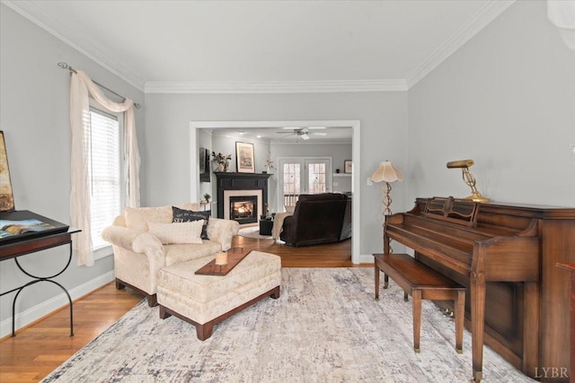 352 Wild Turkey Rd, Lynchburg, VA 24502 - living area with wood finished floors, a glass covered fireplace, ornamental molding, and a ceiling fan