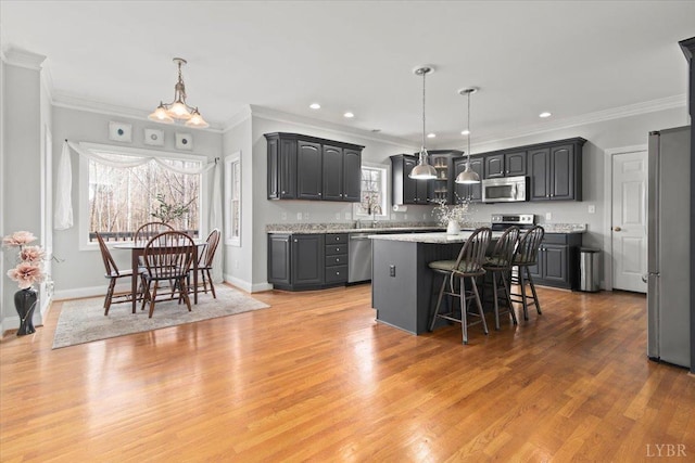 352 Wild Turkey Rd, Lynchburg, VA 24502 - kitchen featuring stainless steel appliances, a breakfast bar, crown molding, a center island, and light wood finished floors