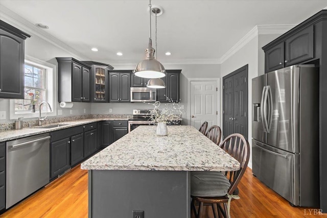 352 Wild Turkey Rd, Lynchburg, VA 24502 - kitchen with stainless steel appliances, a breakfast bar area, a center island, crown molding, and light wood-type flooring