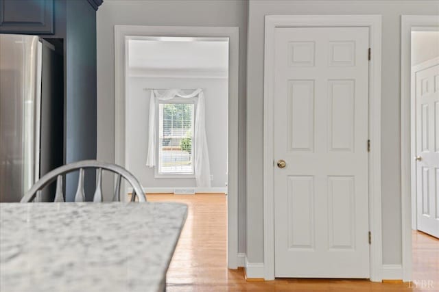 352 Wild Turkey Rd, Lynchburg, VA 24502 - kitchen with freestanding refrigerator, blue cabinets, and light wood finished floors