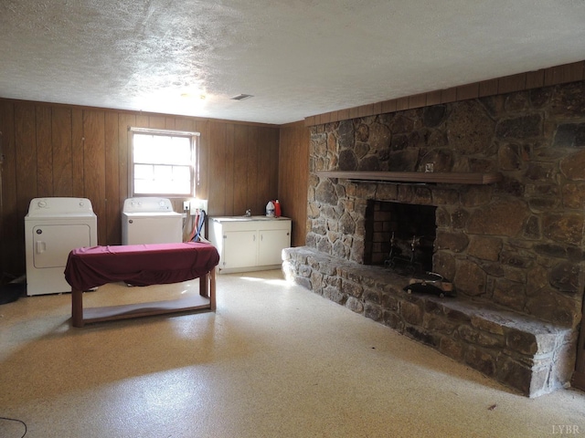 723 Custer Dr, Lynchburg, VA 24502 - bedroom with wood walls, independent washer and dryer, a textured ceiling, visible vents, and a stone fireplace