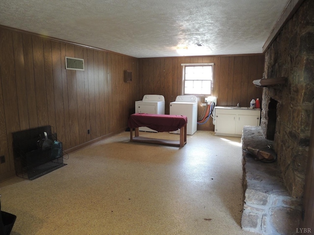 723 Custer Dr, Lynchburg, VA 24502 - bedroom featuring a fireplace, a textured ceiling, independent washer and dryer, and wooden walls
