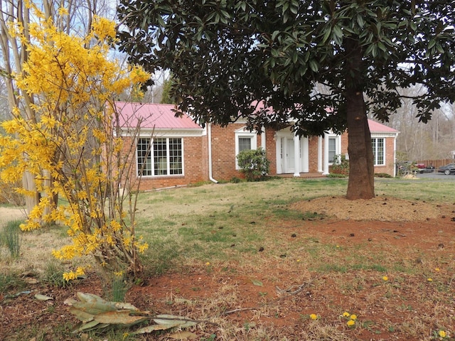 723 Custer Dr, Lynchburg, VA 24502 - view of property hidden behind natural elements featuring brick siding, a front lawn, and metal roof