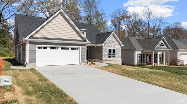 117 Craftsman Way, Lynchburg, VA 24503 - view of front of home featuring a front lawn, driveway, stone siding, and an attached garage