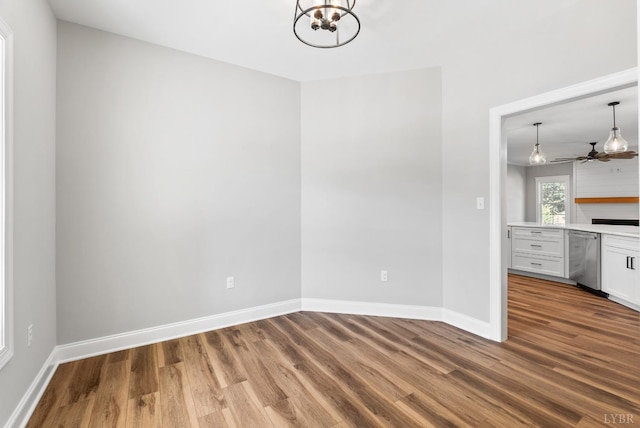 117 Craftsman Way, Lynchburg, VA 24503 - unfurnished dining area featuring ceiling fan with notable chandelier, baseboards, and wood finished floors