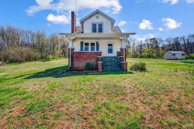 501 W Spencer Rd, Hurt, VA 24563 - view of front of house with a chimney, a front yard, a porch, and brick siding