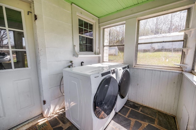 501 W Spencer Rd, Hurt, VA 24563 - laundry area featuring washer and dryer, dark stone finish floors, and wooden walls