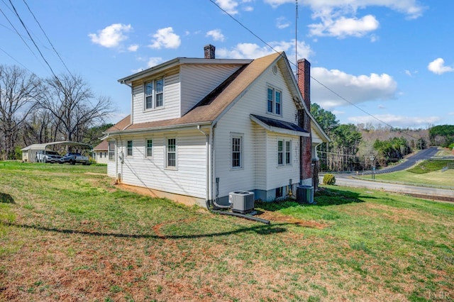 501 W Spencer Rd, Hurt, VA 24563 - view of property exterior featuring a chimney, a lawn, a detached carport, and central AC unit