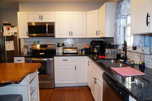 203 Marshall St, Brookneal, VA 24528 - kitchen with stainless steel appliances, white cabinets, decorative backsplash, a sink, and dark wood-style floors