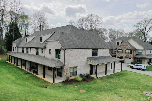 1031 Tori Ct, Forest, VA 24551 - view of front facade with cooling unit, a front yard, a patio area, and brick siding