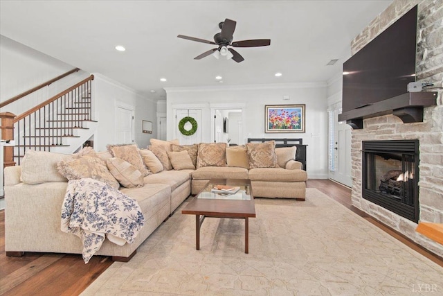 1031 Tori Ct, Forest, VA 24551 - living room with a fireplace, wood finished floors, ornamental molding, ceiling fan, and stairway