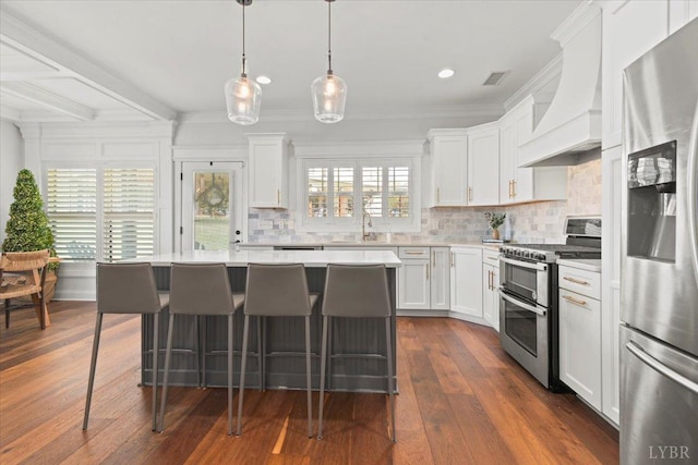 1031 Tori Ct, Forest, VA 24551 - kitchen with appliances with stainless steel finishes, custom range hood, light countertops, a sink, and a breakfast bar area