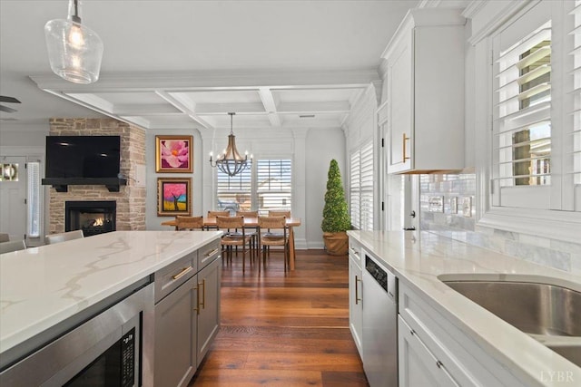 1031 Tori Ct, Forest, VA 24551 - kitchen featuring appliances with stainless steel finishes, a fireplace, dark wood-style floors, coffered ceiling, and open floor plan