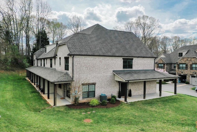 1031 Tori Ct, Forest, VA 24551 - view of property exterior with a patio, a lawn, roof with shingles, and brick siding
